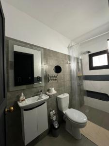 uma casa de banho com um WC, um lavatório e uma televisão em VILLA ADAM TANGIER em Tânger