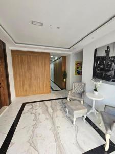 a lobby with a chair and a table and a door at APARTMENT IVIL - ELIA RESIDENCE in Becici