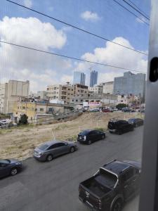 a group of cars parked on a street with buildings at Gentle Breeze Studio 2 in Amman