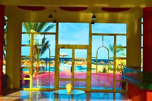 a lobby with a view of a resort with a pool at Hostmark Zabargad Beach Resort in Abū Ghuşūn