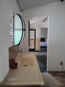 a large bath tub in a room with a mirror at Rosane's casa in Guapimirim