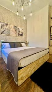 a bedroom with a large bed with blue pillows at Del Regno Holiday House in Pompei