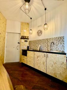 a kitchen with a sink and a refrigerator at Del Regno Holiday House in Pompei