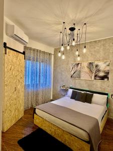 a bedroom with a large bed and a large window at Del Regno Holiday House in Pompei