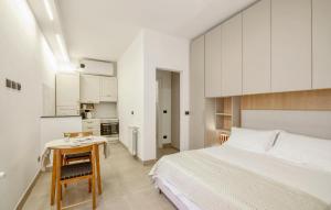 カモーリにあるAmazing Apartment In Camogli With Kitchenのベッドルーム1室(ベッド1台、テーブル付)、キッチン