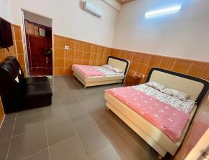 a room with two beds and a chair in it at LAN168 in Long Hai