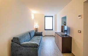a living room with a couch and a television at Beautiful Apartment In Castel Focognano in Castel Focognano