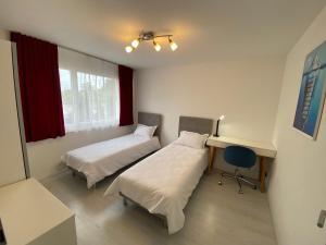 a hospital room with two beds and a desk at Cozy Escape House 12 min away from Zurich Main Station in Ober Urdorf