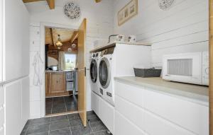 a white laundry room with a washer and dryer at Cozy Home In Bogense With Wifi in Bogense
