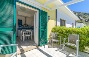 a door leading to a patio with chairs and a table at Nice Apartment In Framura With Kitchen in Framura