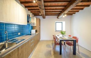 a kitchen with a table with chairs and a sink at Beautiful Apartment In Castel Focognano in Castel Focognano