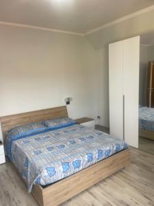 1 dormitorio con cama y pared blanca en Casa vacanze Abbazia, en Serravalle Scrivia