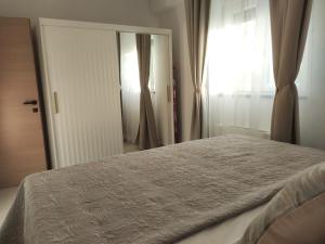 a bedroom with a bed and a large window at Vivien in Podstrana +29 photos