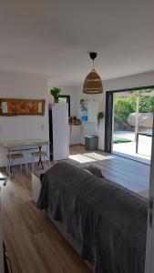 a bedroom with a bed and a kitchen with a refrigerator at Casa corsica in Pianottoli-Caldarello