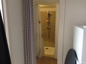 a bathroom with a shower with a shower curtain at la loggia in Porto-Vecchio