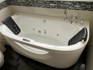 a white bath tub in a bathroom at Cozy Escape House 12 min away from Zurich Main Station in Ober Urdorf