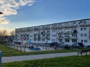 a large building with a playground in front of it at Natalia in Puck