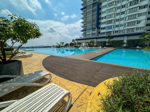 a swimming pool next to a large building at Palmyra Residence Whole Condo in Kajang