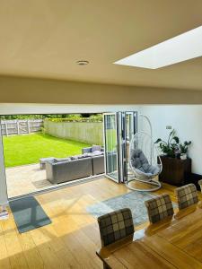 a living room with a couch and a chair at "Tranquil Village Hideaway Bungalow"near Kings Lynn in Kings Lynn