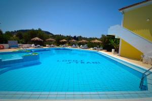 a swimming pool with a pool table and chairs at Lofos Strani in Zakynthos Town