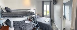 a bedroom with two bunk beds in a room at LE MEDITERRANEEN Montargis in Montargis