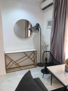a living room with a mirror and a couch at HAS Shortlet in Lekki