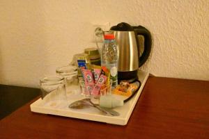 a tray with a coffee pot on a table at ADAMAOUA GRAND HOTEL AKWA in Douala
