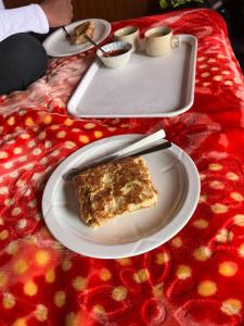 a slice of cake on a plate on a table at Wanderlust Cottage Pangong Lake, Lukung, in Lukung