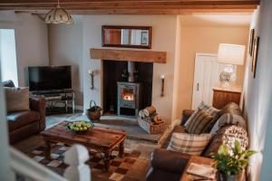 a living room with a couch and a fireplace at Gatecroft House, Garrigill in Garrigill