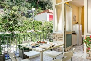 a balcony with a table with a bowl of fruit on it at Rooftop Nerano - Amazing Sea View in Nerano