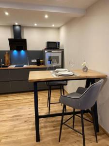 a kitchen with a table with two chairs and a counter at Downtown No 4 in Bad Soden-Salmünster