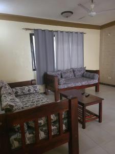 a living room with a couch and a table at Picho two bedroom apartment in Malindi