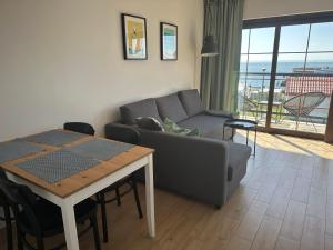 a living room with a couch and a table at ORKAN 2 in Kuźnica