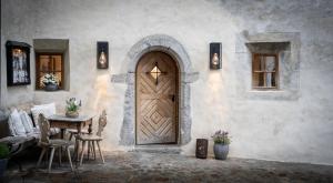 a wooden door in a building with a table and a tableablish at Hotel Ansitz Steinbock in Villandro