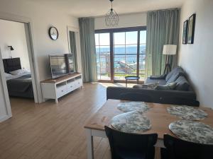 a living room with a couch and a table with chairs at ORKAN 2 in Kuźnica