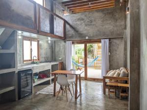 a kitchen with a table and a dining room at Hermanos Perdidos Surf in Las Tunas