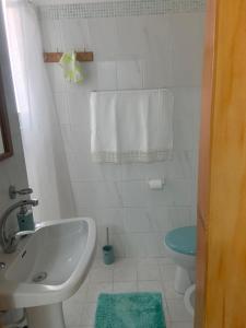 a bathroom with a sink and a toilet at Casa Teresina in Castellabate