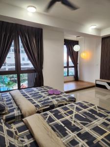 a bedroom with two beds and a large window at Bali Residence Impian Raudah in Melaka