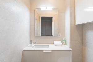 a bathroom with a sink and a mirror at GuestReady - Relaxing stay in Rio Tinto in Rio Tinto