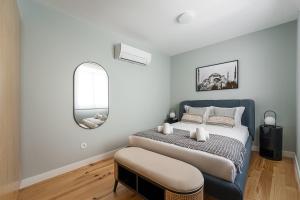 a bedroom with a large bed and a mirror at GuestReady - Lux staycation in Boavista in Porto
