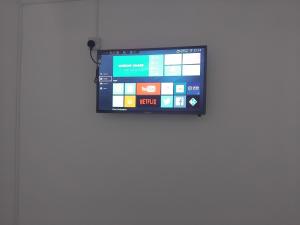 a flat screen tv hanging on a wall at Casa Brillo in London