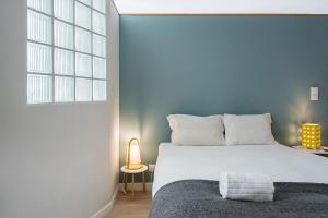 Ένα ή περισσότερα κρεβάτια σε δωμάτιο στο GuestReady - Porto by Pilar Ridge