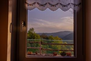 a window with a view of a mountain view at Sunset House - Casa al Tramonto in Selva di Progno