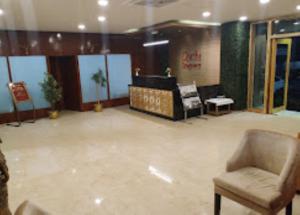a lobby with a chair and a waiting room at Hotel Richi Regency Bhubaneswar in Bhubaneshwar