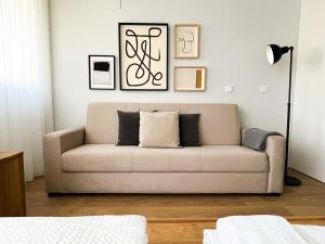 a living room with a couch and pictures on the wall at GuestReady - Senhora da Hora stay near City Golf in Senhora da Hora