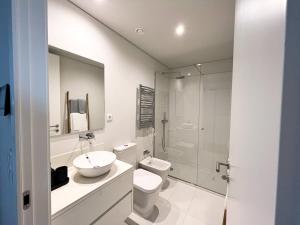 a bathroom with a sink and a toilet and a shower at GuestReady - Senhora da Hora stay near City Golf in Senhora da Hora