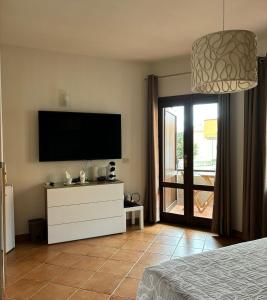 a bedroom with a flat screen tv on the wall at Mare Fuori in Palau