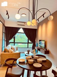 a living room with a table and a couch at Maison life 小居屋 Jesselton Quay CityPads in Kota Kinabalu