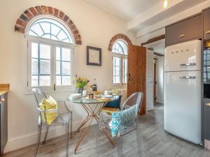 a kitchen with a table and chairs and a refrigerator at The Stilts in Bewdley