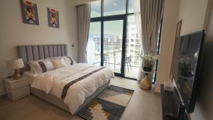 a bedroom with a bed and a large window at Aaderi super Studio in Dubai